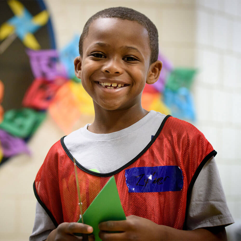 photo of child making paper crafts at saturday hoops